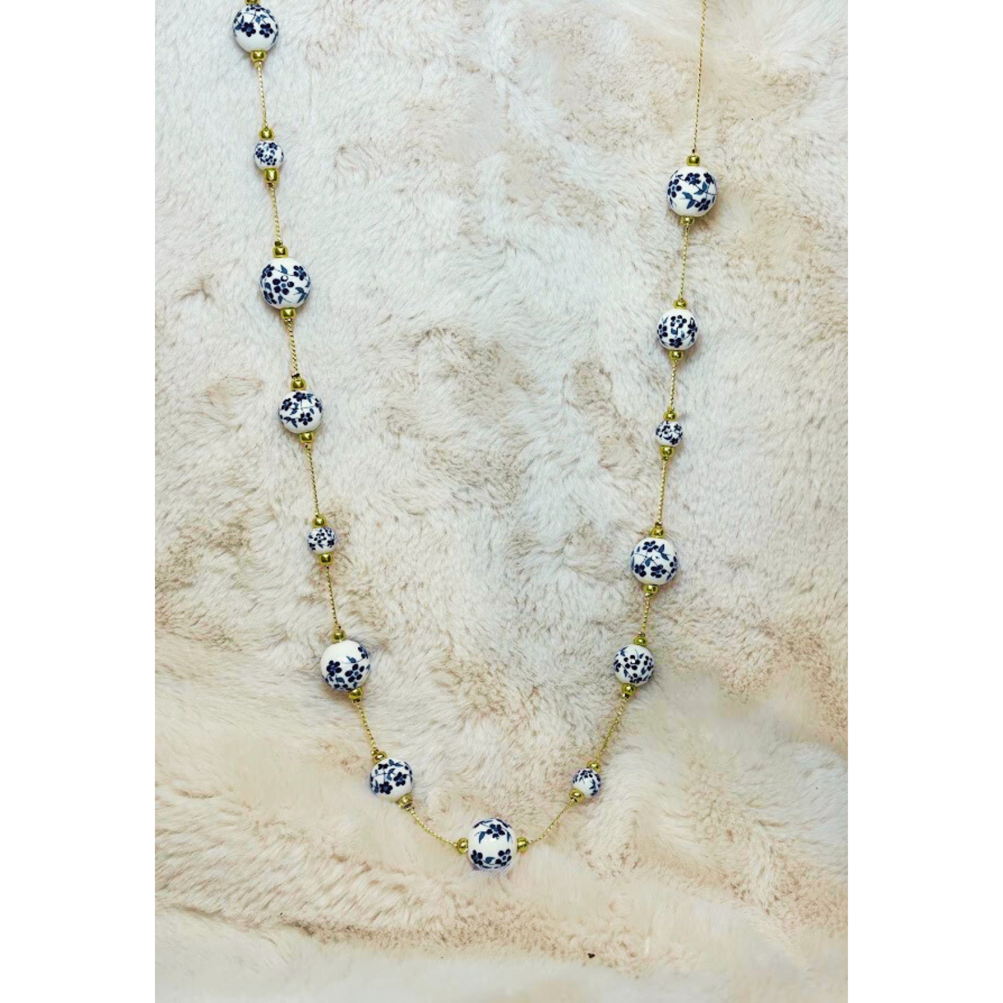 33 inch gold tone necklace with white and blue cottage core beads