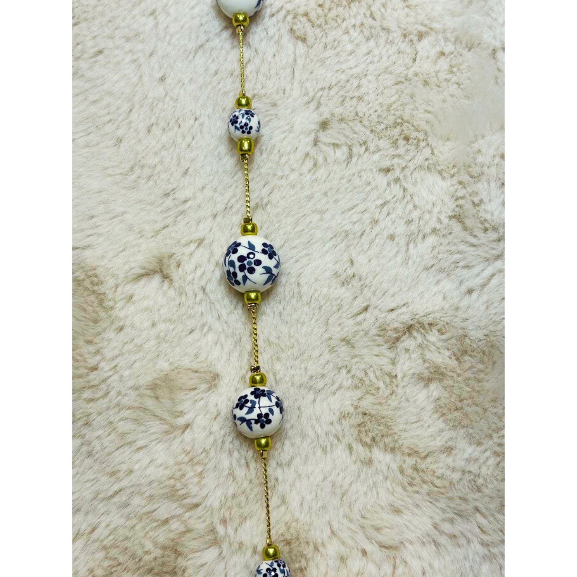 33 inch gold tone necklace with white and blue cottage core beads