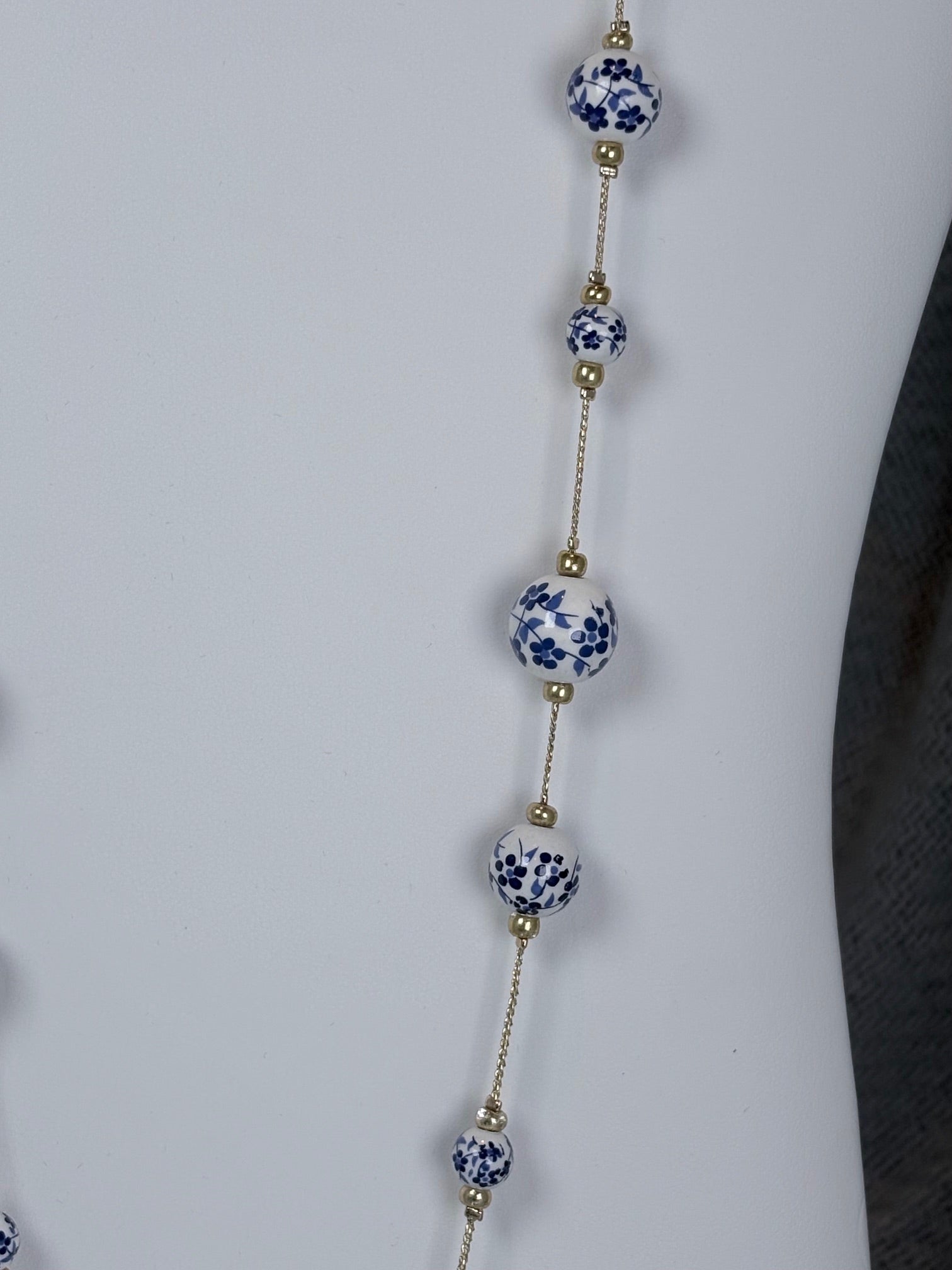 33 inch gold tone necklace with white and blue cottage core beads